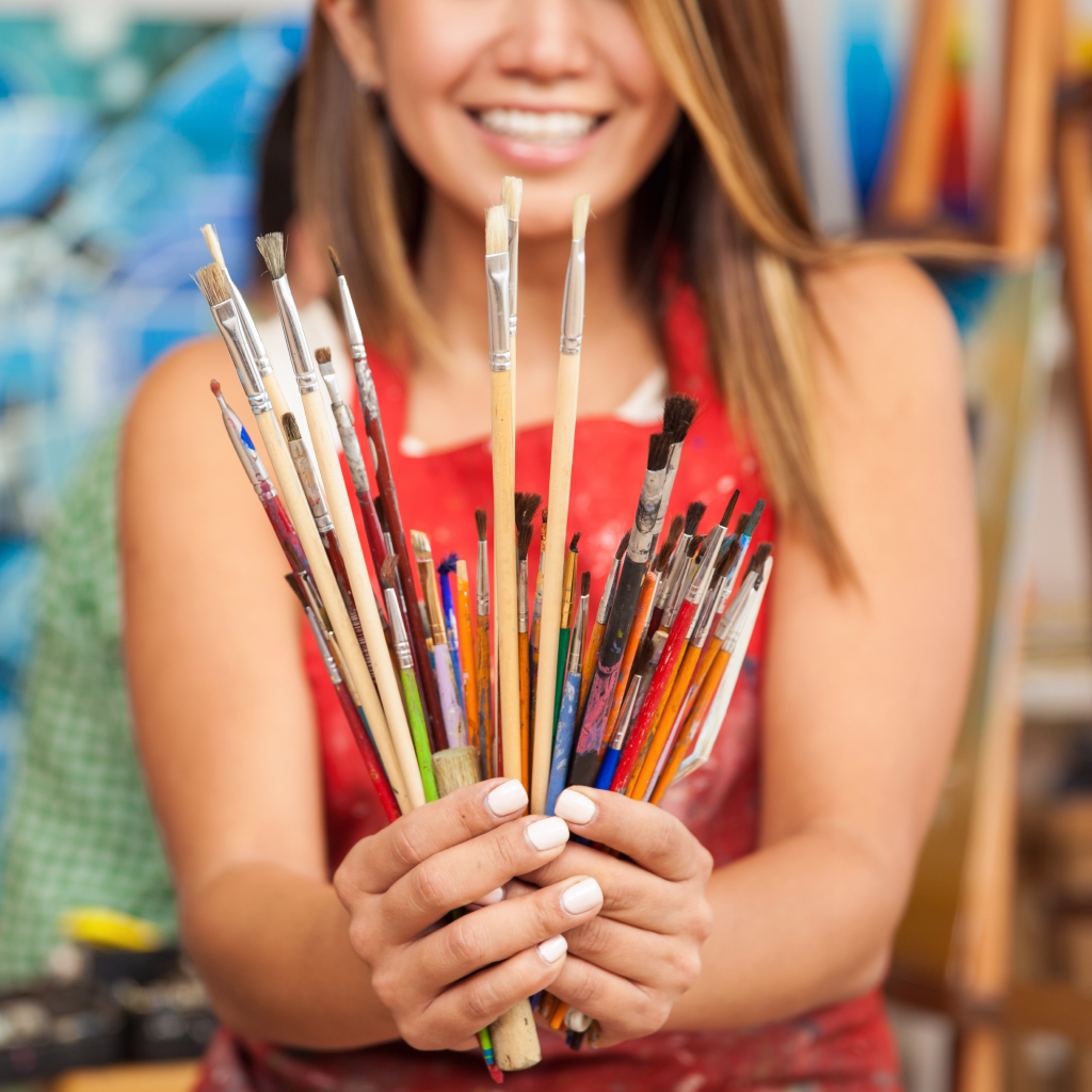 holding paint brushes